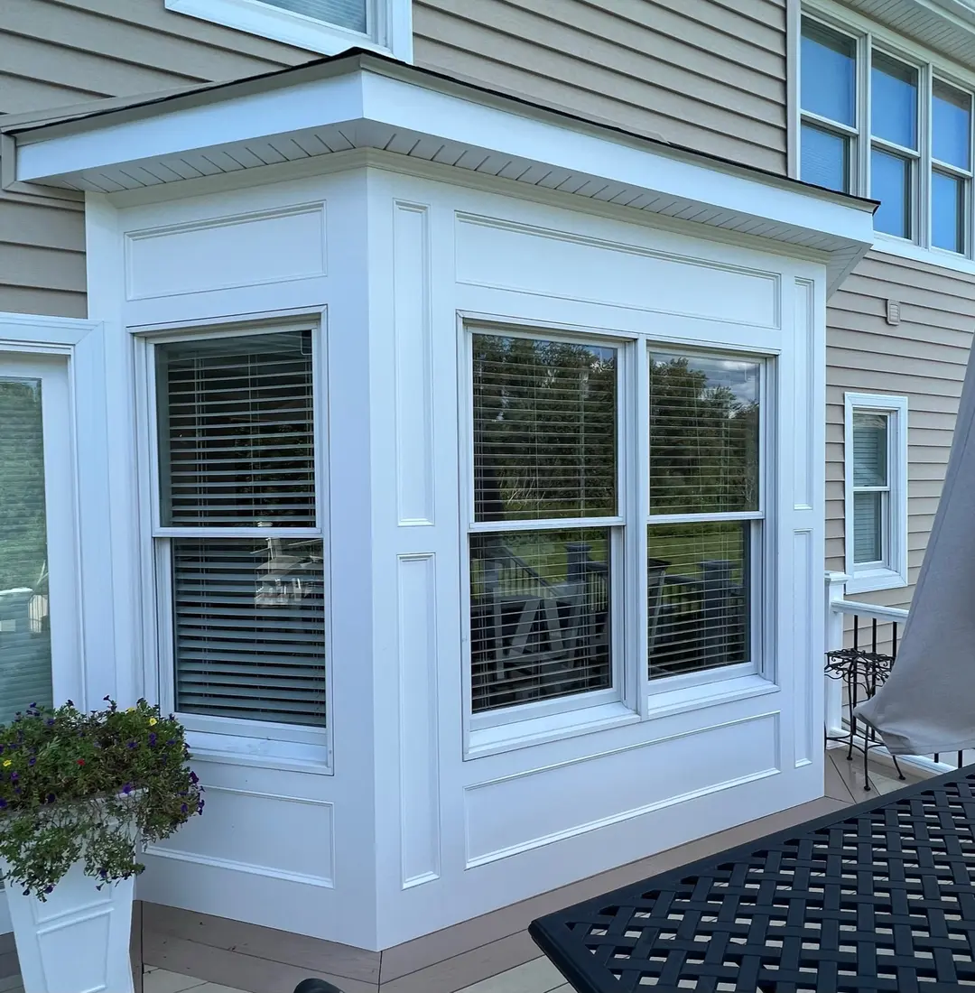 White Bay Window installed with new tan vinyl siding. To help be more energy efficient.